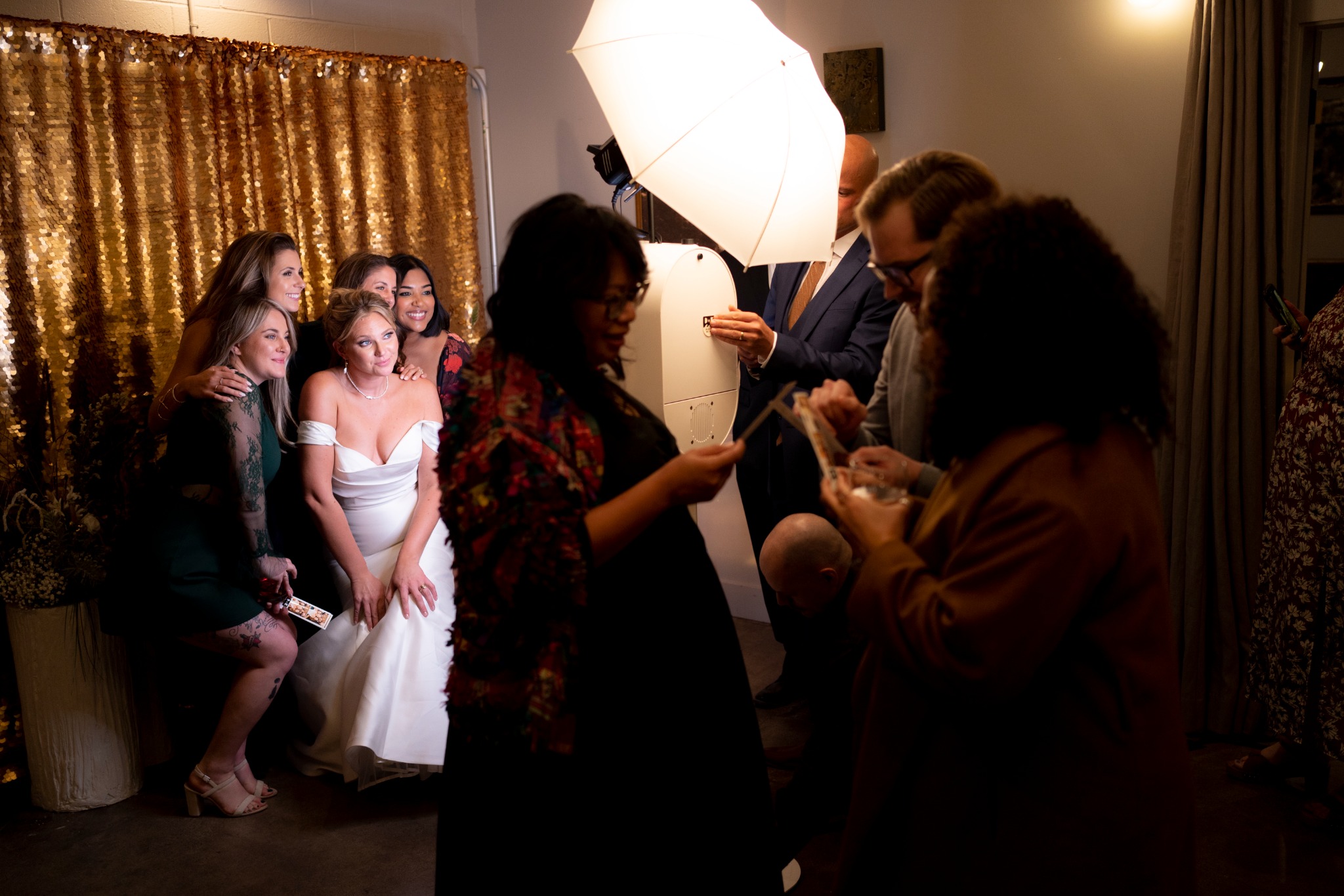 Guests enjoying a KPTZ print booth at a wedding